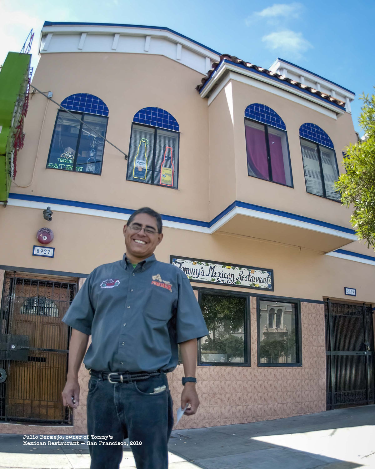 Man standing in front of a building with a sign that reads Tommy's Mexican Restaurant'.
