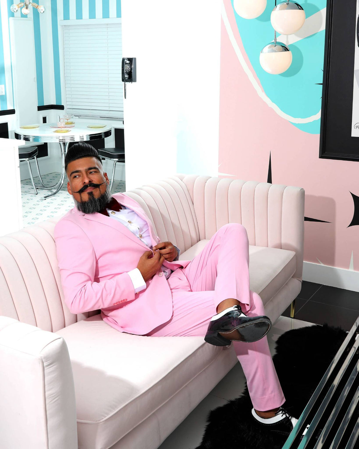 A male pinup model in a pink suit from the book "Vestige: Twenty Years of Modern Pin-Up"